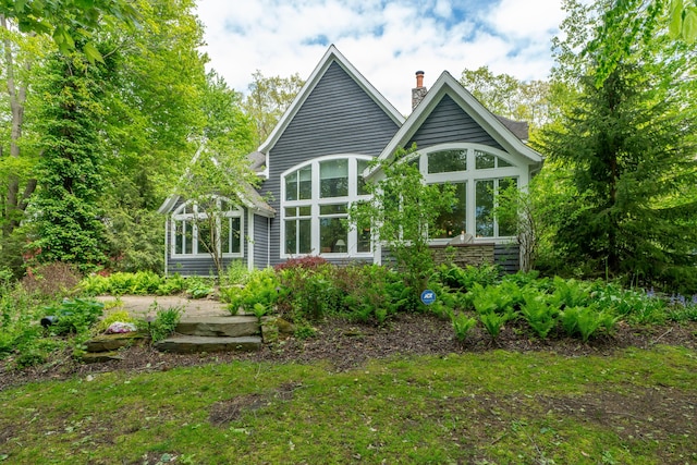 10543 Lakeshore Dr, West Olive, MI 49460 - back of property featuring a sunroom and a chimney
