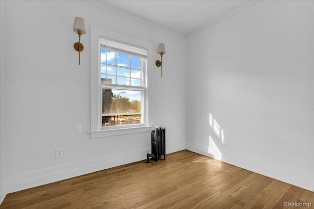 756 Delaware St, Detroit, MI 48202 - unfurnished room featuring radiator heating unit, crown molding, wood finished floors, and baseboards