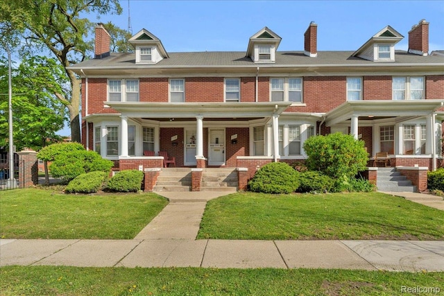 756 Delaware St, Detroit, MI 48202 - view of front of home with covered porch, brick siding, and a front lawn
