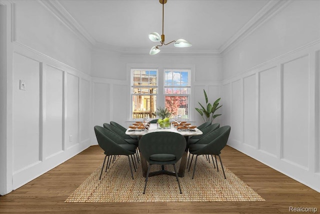 756 Delaware St, Detroit, MI 48202 - dining space featuring a decorative wall, a chandelier, ornamental molding, wood finished floors, and a wainscoted wall