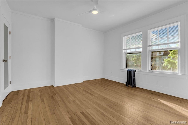 756 Delaware St, Detroit, MI 48202 - unfurnished room featuring radiator heating unit, light wood finished floors, a ceiling fan, ornamental molding, and baseboards