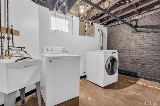 756 Delaware St, Detroit, MI 48202 - washroom featuring washer and clothes dryer, brick wall, and wood finished floors