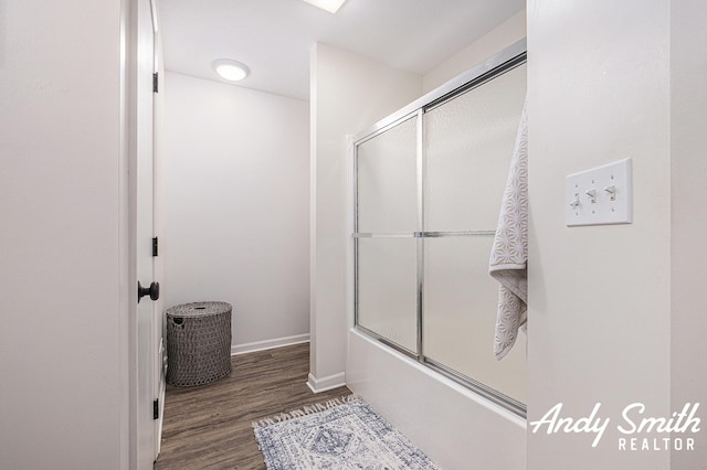 319 Nestlewood Dr Unit 3, Holland, MI 49424 - bathroom with enclosed tub / shower combo, wood finished floors, and baseboards