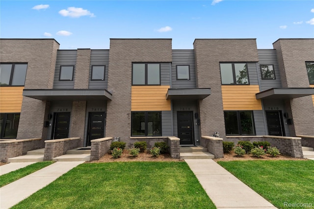 7614 Kipling Unit 15, Detroit, MI 48206 - view of front of property with a front yard and brick siding