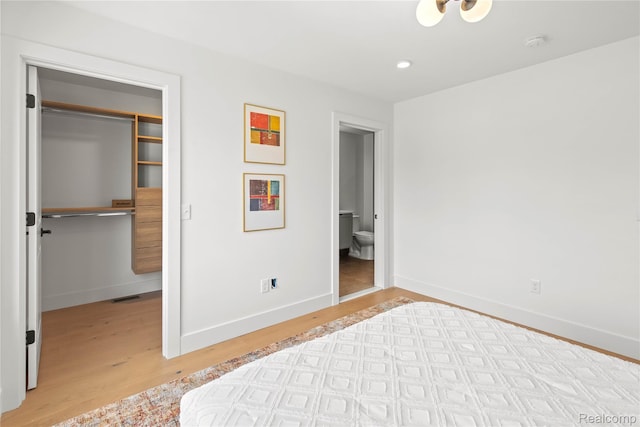 7614 Kipling Unit 15, Detroit, MI 48206 - bedroom with light wood-style floors, a spacious closet, baseboards, and recessed lighting