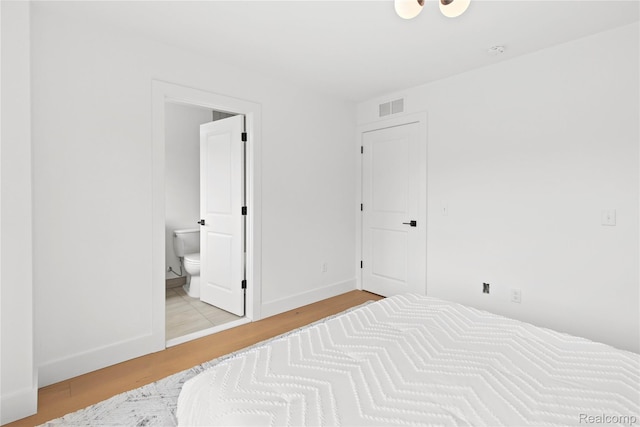 7614 Kipling Unit 15, Detroit, MI 48206 - unfurnished bedroom with wood finished floors, connected bathroom, and baseboards