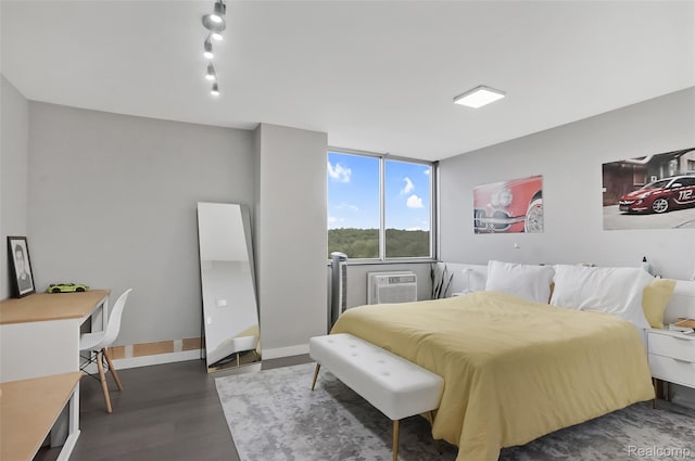 1050 Wall St Unit 8F, Ann Arbor, MI 48105 - bedroom featuring wood finished floors, a wall mounted air conditioner, and baseboards