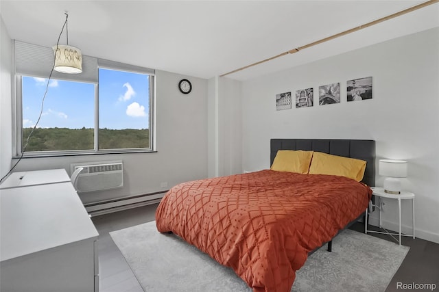 1050 Wall St Unit 8F, Ann Arbor, MI 48105 - bedroom with baseboard heating, a wall mounted AC, and baseboards