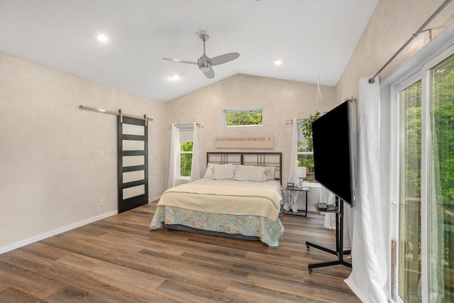 4958 Juniper Rdg, Newaygo, MI 49337 - bedroom featuring a barn door, multiple windows, wood finished floors, high vaulted ceiling, and recessed lighting