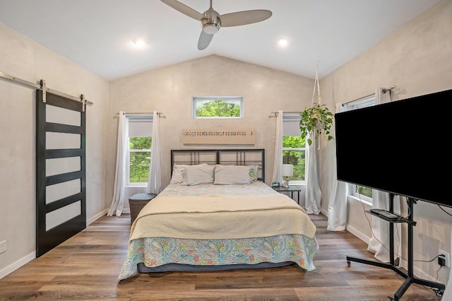 4958 Juniper Rdg, Newaygo, MI 49337 - bedroom with a barn door, vaulted ceiling, baseboards, ceiling fan, and wood finished floors