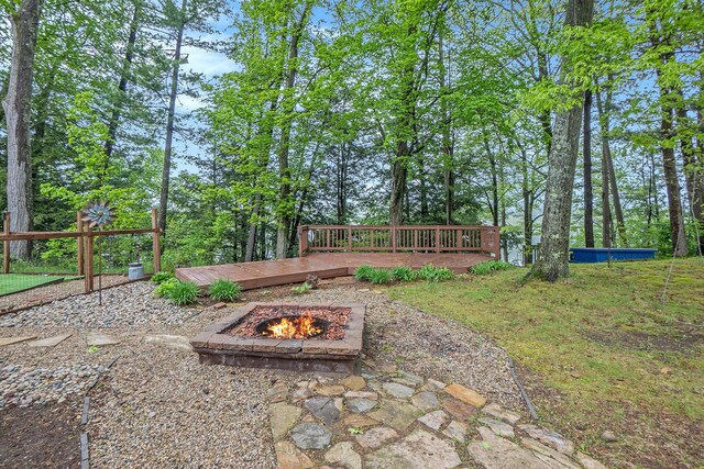 4958 Juniper Rdg, Newaygo, MI 49337 - view of yard featuring an outdoor fire pit and a wooden deck