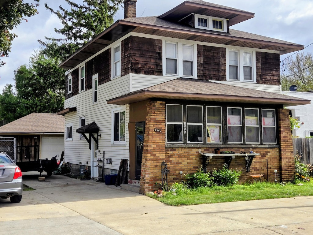 1555 Chicago Dr SW, Wyoming, MI 49509 - traditional style home with a chimney, a shingled roof, and an outdoor structure
