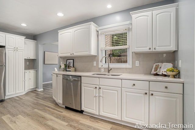 1046 Kenesaw Dr SE, East Grand Rapids, MI 49506 - kitchen featuring appliances with stainless steel finishes, a sink, white cabinetry, backsplash, and recessed lighting