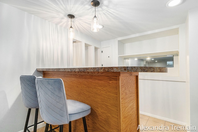 1046 Kenesaw Dr SE, East Grand Rapids, MI 49506 - kitchen featuring baseboards, a kitchen breakfast bar, light tile patterned floors, hanging light fixtures, and open shelves