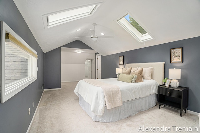 1046 Kenesaw Dr SE, East Grand Rapids, MI 49506 - bedroom with a skylight, carpet floors, vaulted ceiling, baseboards, and a ceiling fan