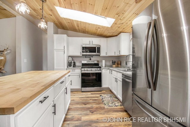 4527 Clareola Ave, Lake, MI 48632 - kitchen featuring appliances with stainless steel finishes, a sink, a skylight, vaulted ceiling, and butcher block counters