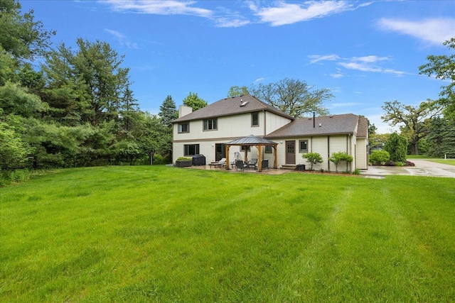 4047 Ramsgate Ct, Ann Arbor, MI 48103 - rear view of house with a gazebo, a patio, a yard, and a chimney