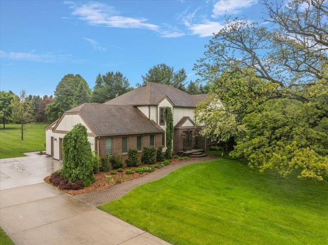 4047 Ramsgate Ct, Ann Arbor, MI 48103 - tudor house featuring driveway, a front lawn, and brick siding