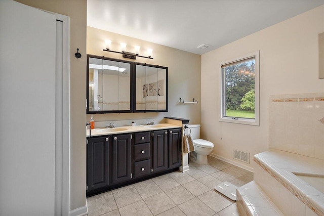 4047 Ramsgate Ct, Ann Arbor, MI 48103 - bathroom featuring double vanity, a garden tub, tile patterned flooring, toilet, and baseboards