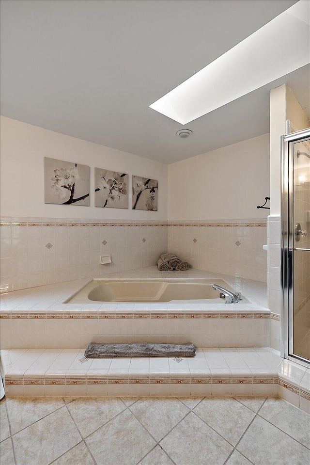 4047 Ramsgate Ct, Ann Arbor, MI 48103 - bathroom with tile patterned floors, a garden tub, a skylight, and a stall shower