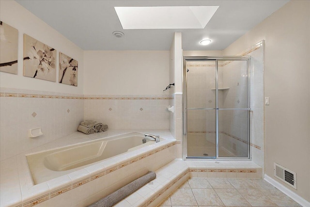 4047 Ramsgate Ct, Ann Arbor, MI 48103 - full bath featuring a garden tub, a shower stall, a skylight, and tile patterned floors