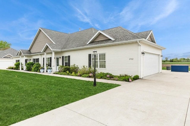 1732 Peachtree Path Unit 4, Stevensville, MI 49127 - view of front of house with driveway, a shingled roof, a front lawn, and a garage