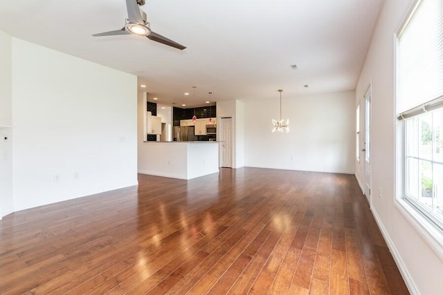 1732 Peachtree Path Unit 4, Stevensville, MI 49127 - unfurnished living room with a chandelier, ceiling fan, wood-type flooring, baseboards, and recessed lighting