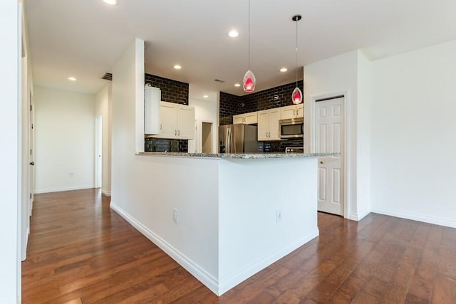 1732 Peachtree Path Unit 4, Stevensville, MI 49127 - kitchen featuring appliances with stainless steel finishes, dark wood-style floors, decorative light fixtures, baseboards, and light stone counters