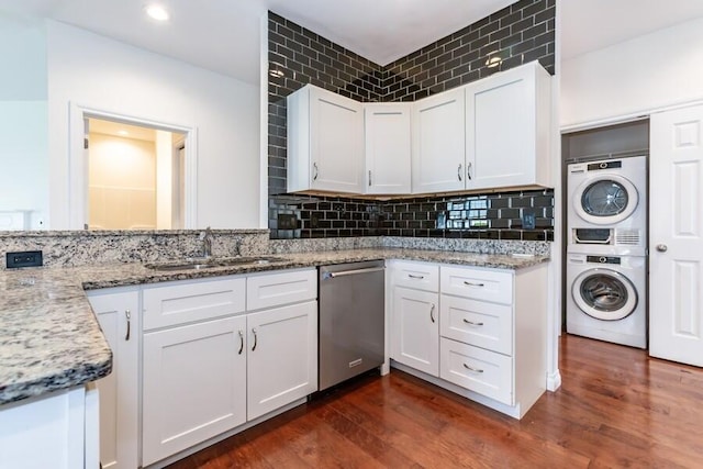 1732 Peachtree Path Unit 4, Stevensville, MI 49127 - kitchen with dishwasher, stacked washer and clothes dryer, a sink, white cabinetry, and light stone counters