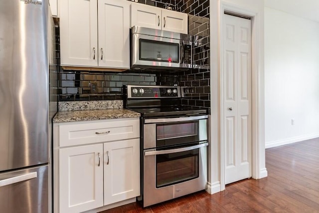 1732 Peachtree Path Unit 4, Stevensville, MI 49127 - kitchen featuring stainless steel appliances, decorative backsplash, baseboards, and light stone countertops