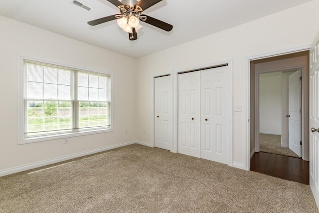 1732 Peachtree Path Unit 4, Stevensville, MI 49127 - unfurnished bedroom with carpet flooring, multiple closets, baseboards, and a ceiling fan