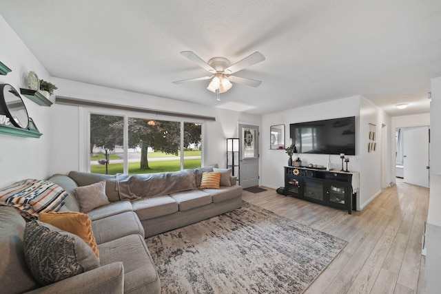2837 Elmwood Dr, Adrian, MI 49221 - living area with a ceiling fan and light wood-style floors