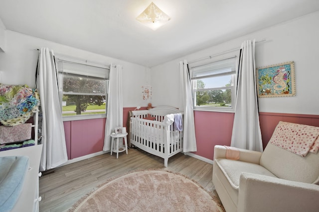 2837 Elmwood Dr, Adrian, MI 49221 - bedroom featuring wood finished floors and a nursery area