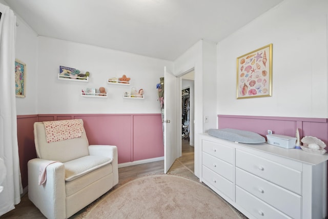 2837 Elmwood Dr, Adrian, MI 49221 - living area featuring wainscoting, light wood-style flooring, and a decorative wall