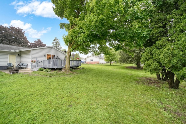 2837 Elmwood Dr, Adrian, MI 49221 - view of green lawn with a wooden deck and a patio area