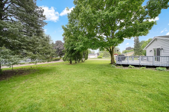 2837 Elmwood Dr, Adrian, MI 49221 - view of grassy yard with a deck
