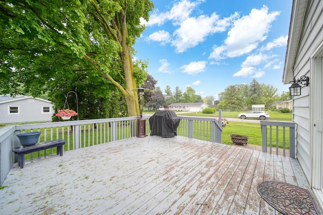 2837 Elmwood Dr, Adrian, MI 49221 - wooden terrace with a grill, a lawn, and an outdoor fire pit