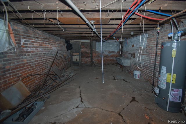 2688 Montgomery St, Detroit, MI 48206 - unfinished below grade area featuring gas water heater and brick wall