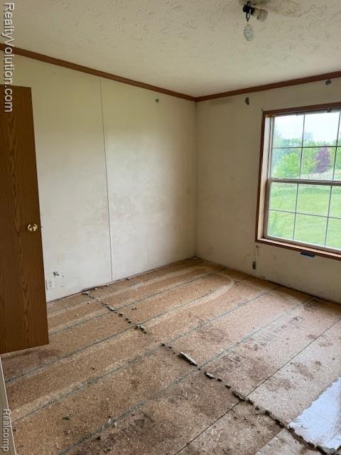5736 Burnside Rd, North Branch, MI 48461 - empty room featuring ornamental molding and a textured ceiling