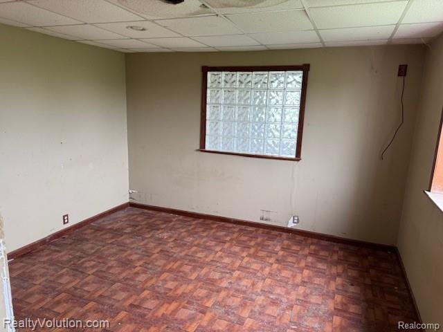 5736 Burnside Rd, North Branch, MI 48461 - unfurnished room featuring a paneled ceiling and baseboards