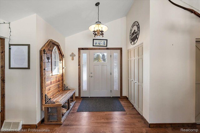 5240 Thomas Rd, Metamora, MI 48455 - entrance foyer with a chandelier, dark wood finished floors, lofted ceiling, and baseboards