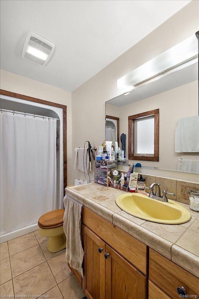 5240 Thomas Rd, Metamora, MI 48455 - bathroom featuring vanity, toilet, a shower with shower curtain, and tile patterned flooring
