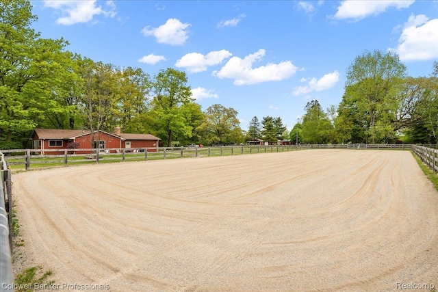 5240 Thomas Rd, Metamora, MI 48455 - deck featuring an enclosed riding area, driveway, and view of scattered trees