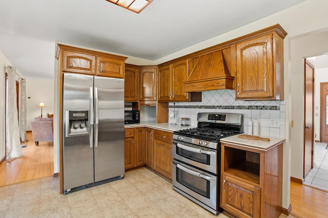 8300 W X Ave, Schoolcraft, MI 49087 - kitchen featuring appliances with stainless steel finishes, custom range hood, brown cabinetry, and light countertops