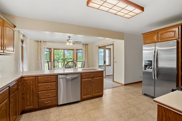 8300 W X Ave, Schoolcraft, MI 49087 - kitchen with stainless steel appliances, brown cabinetry, a peninsula, and light countertops