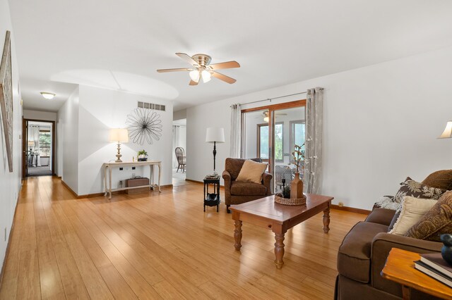 8300 W X Ave, Schoolcraft, MI 49087 - living room featuring ceiling fan, light wood-type flooring, and baseboards
