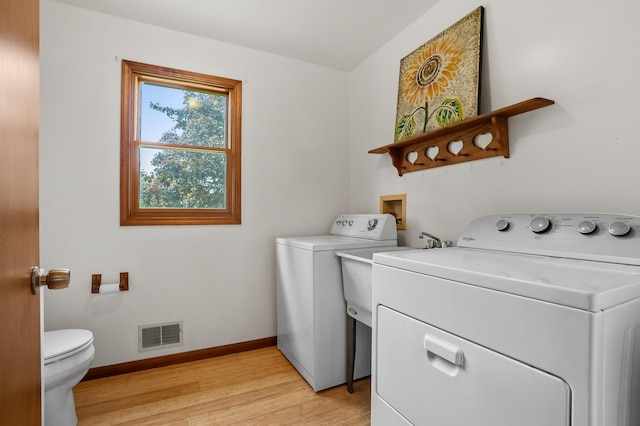 8300 W X Ave, Schoolcraft, MI 49087 - laundry area featuring independent washer and dryer, light wood-type flooring, and baseboards