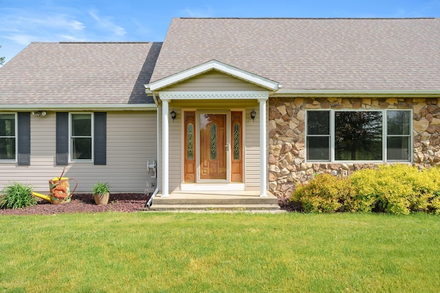 8300 W X Ave, Schoolcraft, MI 49087 - view of front of home with stone siding, a front yard, and a shingled roof
