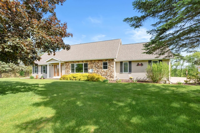 8300 W X Ave, Schoolcraft, MI 49087 - view of front facade featuring stone siding, a front yard, and roof with shingles