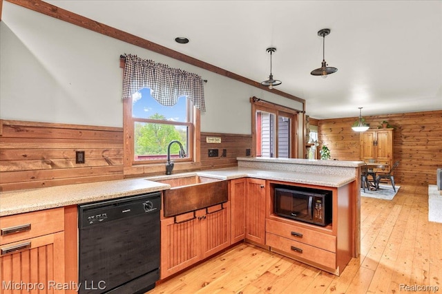 3434 Brown City Rd, Imlay City, MI 48444 - kitchen with black appliances, wooden walls, a sink, a peninsula, and light wood-style flooring